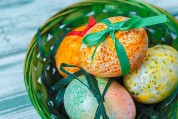 Easter eggs with tulips on blue wooden background