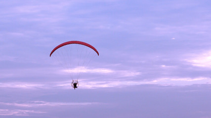 Parachute or paramotor fly in sunset, sport activity
