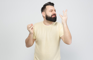 Fototapeta premium The pretty bearded man shows emotionally