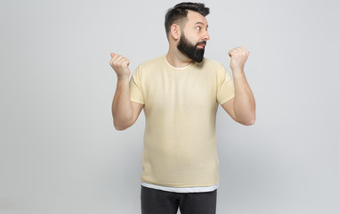Fototapeta premium The pretty bearded man shows emotionally