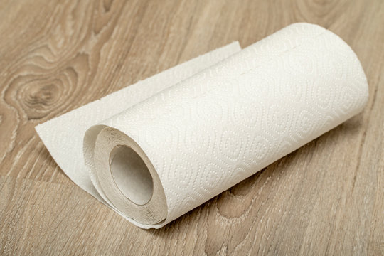 white paper towel roll on wooden background