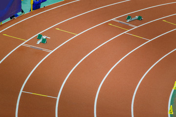 Starting blocks on track line on indoor arena