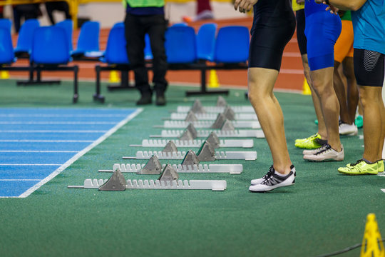 Group of sportsmen before start in sprint running