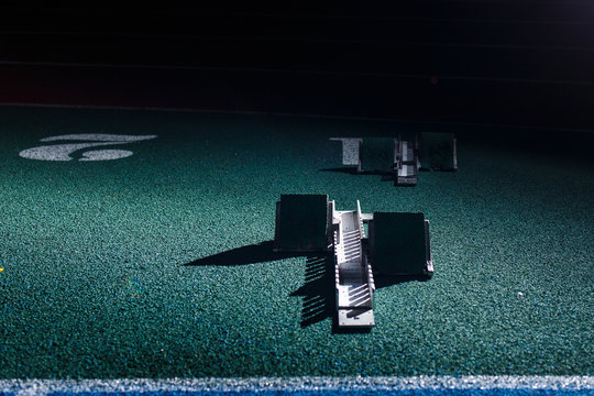 Starting blocks in dark before sprint start line