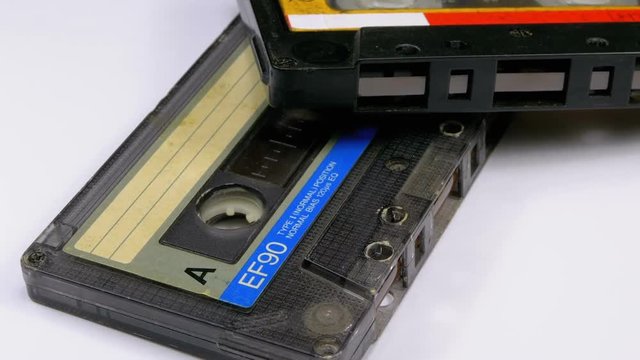 Two Audio Cassettes Rotates on White Background