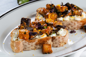 Eggplant and tomato caponata on crusty white bread