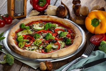 Healthy vegetables and mushrooms vegetarian pizza on wooden background 