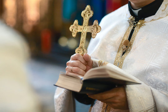 Tools for baby baptism. eley in the hands of a priest. Catholicism, the concept of Christianity