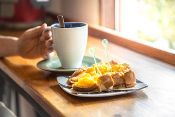 Toast bread and cup of coffee in coffee shop