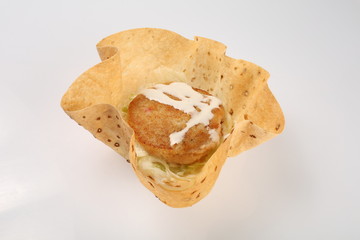 Vegetarian burger in corn tortillas with beetroot, carrots, onions, cabbage and green salad, chickpeas and avocados on a plate
