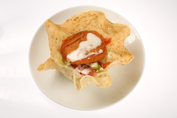 Vegetarian burger in corn tortillas with beetroot, carrots, onions, cabbage and green salad, chickpeas and avocados on a plate