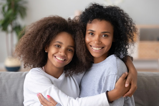 Head shot portrait mixed race girls embracing - Powered by Adobe