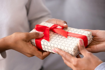 Close up female hands holding gift box