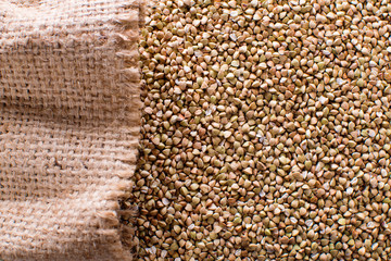 uncooked green buckwheat background, organic vegan food. The texture of burlap. Copy space