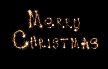 Sparklers forming text MERRY CHRISTMAS on black background