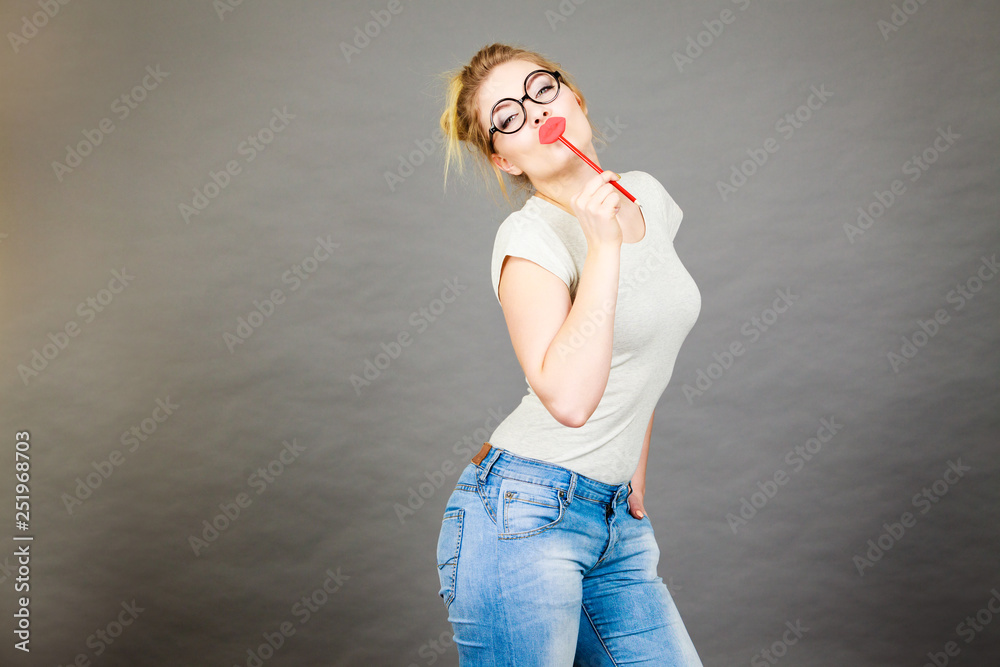 Poster Happy woman holding fake lips on stick