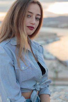 Young woman during the sunset in the mediterranean