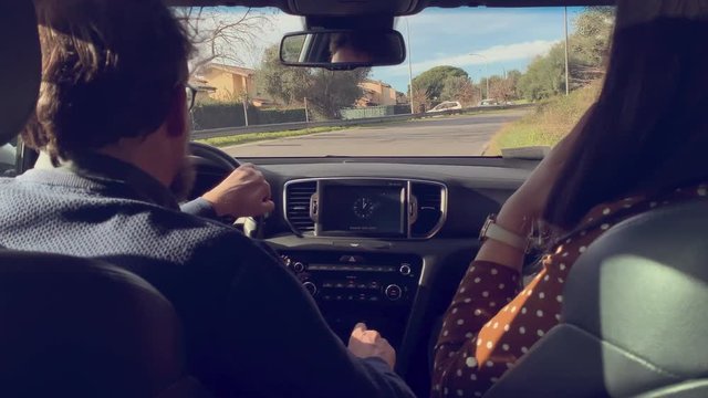 People In Car Driving Shot From Back Seat