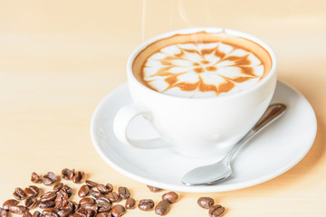 hot cappuccino coffee with nice pattern foam on table