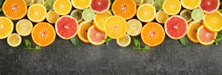 Flat lay composition with ripe citrus fruits on dark background