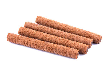 Waffle rolls with chocolate cream on white background