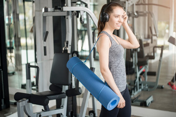 Fototapeta premium Pretty young sport woman is workout with mat in gym, Healthy lifestyle