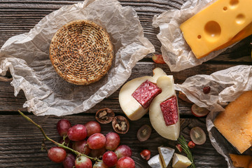 Assortment of tasty cheese on wooden table