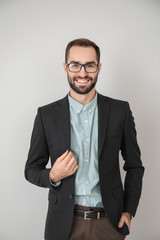 Portrait of young businessman on light background