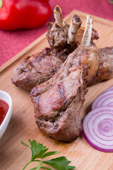 Grilled lamb chops served with ketchup