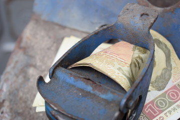 Metal barrel and Ukrainian money, the concept of the cost of gasoline, diesel, gas. Refilling the car. Banknote 100 hryvnia.