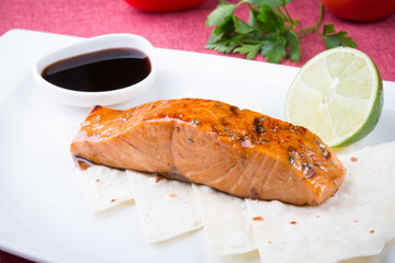 Baled salmon steak served with lime