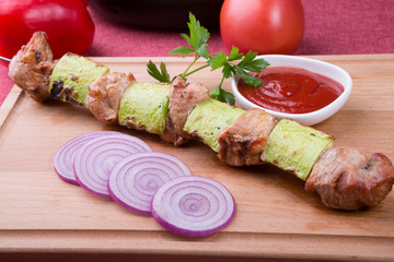 Grilled meat and zucchini ona metal skewer