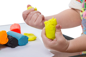 Child with yellow plasticine