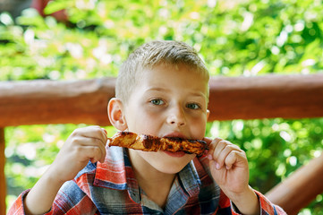 baby boy eating shish kebab