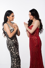 Portrait of Two Miss Asian Women Pageant Beauty Contest in Evening Ball Gown dress, stand snap sexy glamour elegance look waiting final announcement moment, studio lighting white background copy space