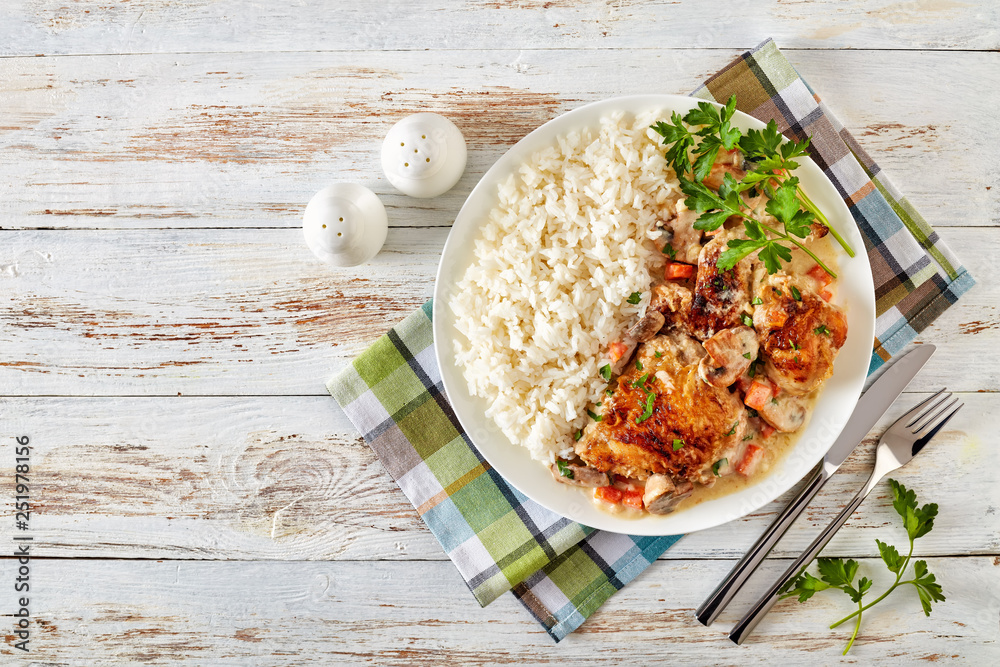 Poster chicken fricassee on a plate with rice