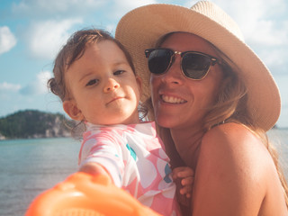 Mother Enjoying A Summer Day On The Beach and swimming pool