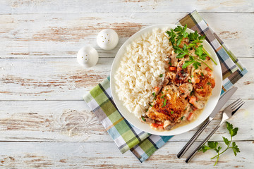 chicken fricassee on a plate with rice