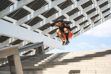 Hispanic Man doing jumping up. Core outdoor workout. Fit man athlete exercising.