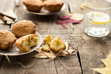 Sweet cupcakes on old wooden background.