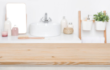 Fototapeta na wymiar Wooden tabletop for product display over defocused bathroom interior background