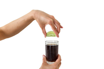 Squeezing the lime into the drink