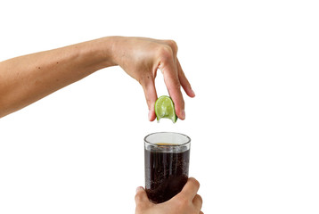 Squeezing the lime into the drink