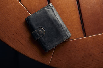 top view of leather grey wallet on wooden table