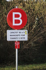 Sign with detail information about the pipe with fire water along the high speed line in the Netherlands