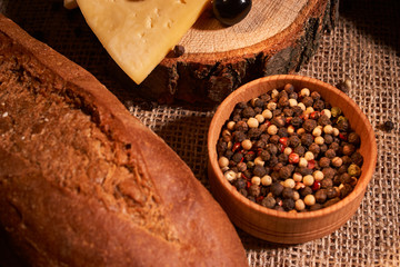 Peppercorns in a wooden bowl on table with food rustic style. Homemade food