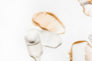 Liquid creamy foundation smudged on white background. Beauty and fashion conception.