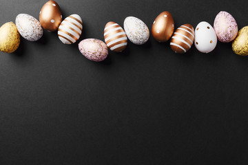 Golden eggs on black background