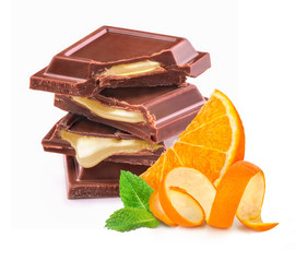 pieces of black chocolate with orange filling on a white background
