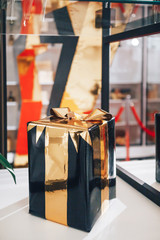 Black and gold box with a gift